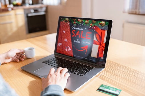 Woman shopping online at Christmas sale, using a laptop and credit card | Image: Unsplash
