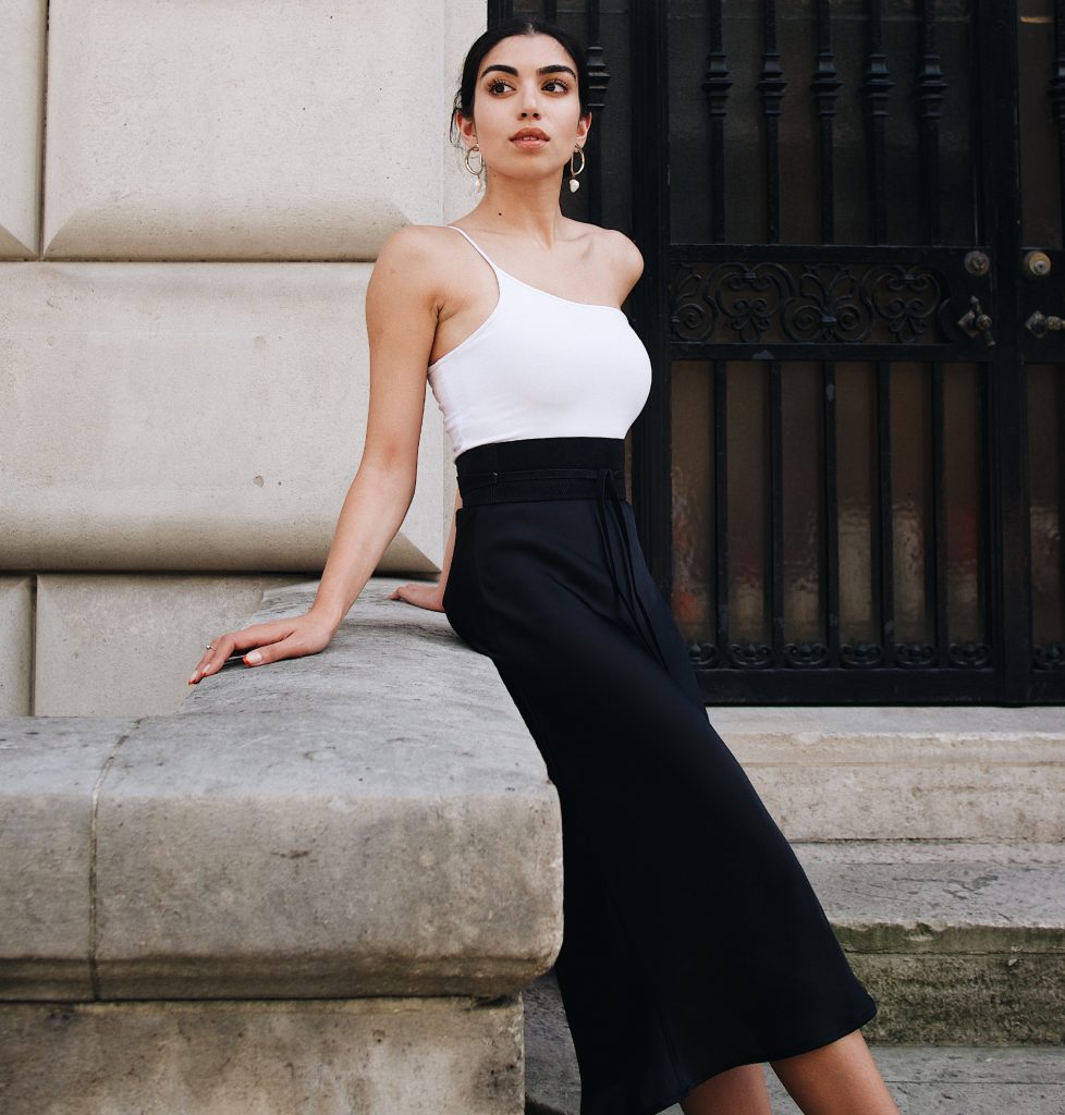 A woman wearing a tight-fitting top and a long, lose skirt | Image: Unsplash