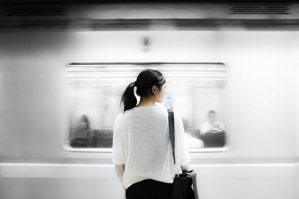 A woman standing outside a train carriage | Image: Unsplash