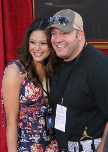 Kevin James posing with his wife Steffiana