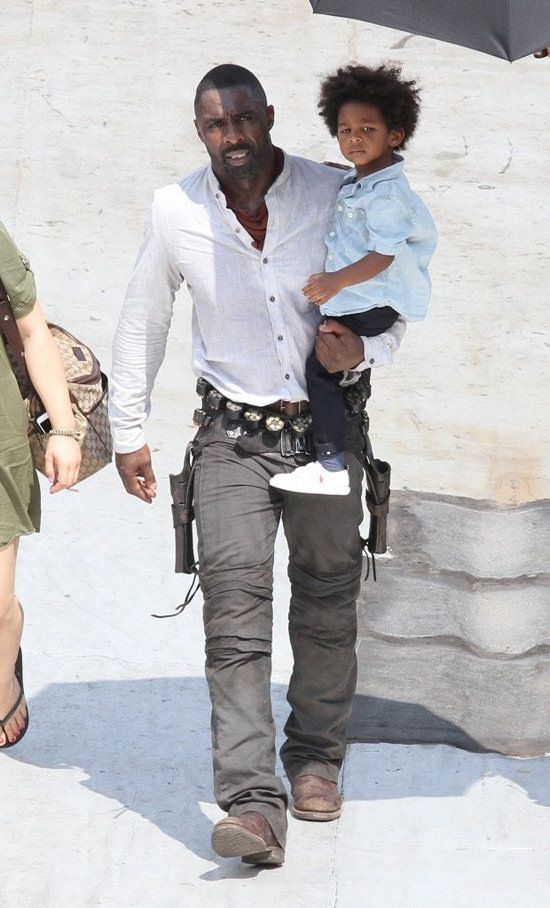 Idris Elba carrying his son Winston 
