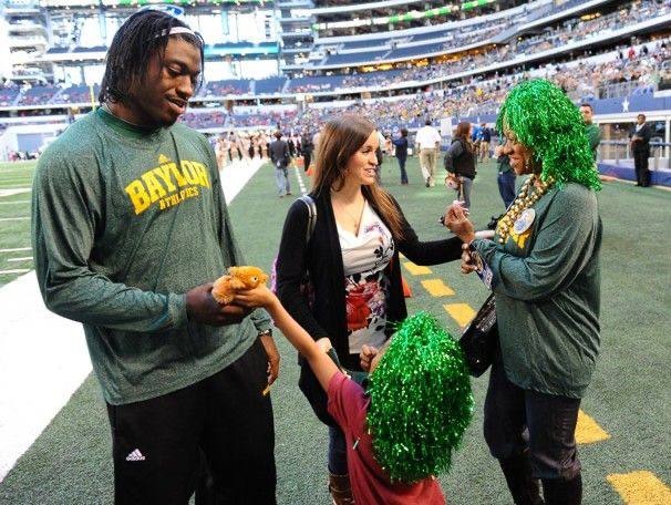 A picture of Rebecca Liddicoat and RgIII at a game. 