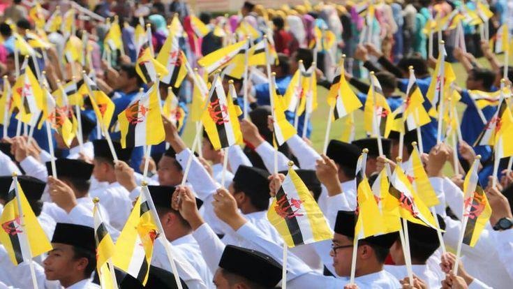 A picture of Brunei natives with their flags