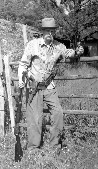 A picture of a cowboy with a Winchester Model 1873 and Colt M1873