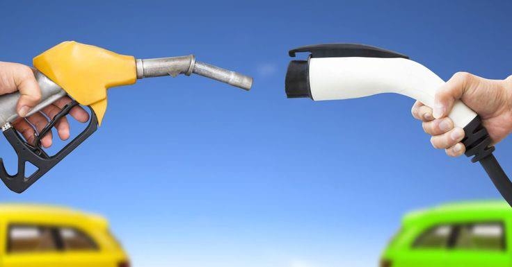 A picture of an Electric car charger and a gasoline car nuzzle