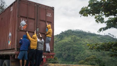 Migrants hanging on the back of a truck