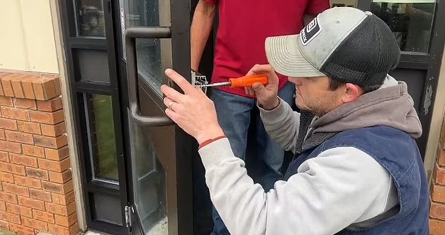 A locksmith changing the locks of the town hall after the elections