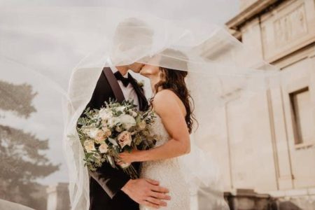 A couple sharing a kiss at their wedding