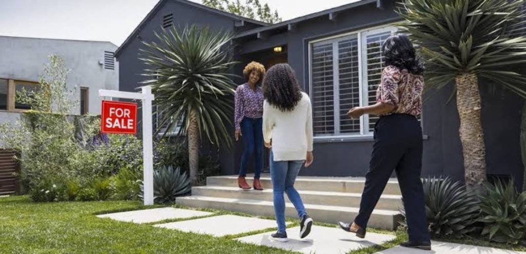 Home buyers walking towards a broker