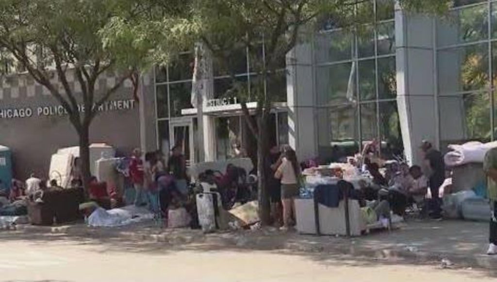 Migrants floating outside Chicago Police Department