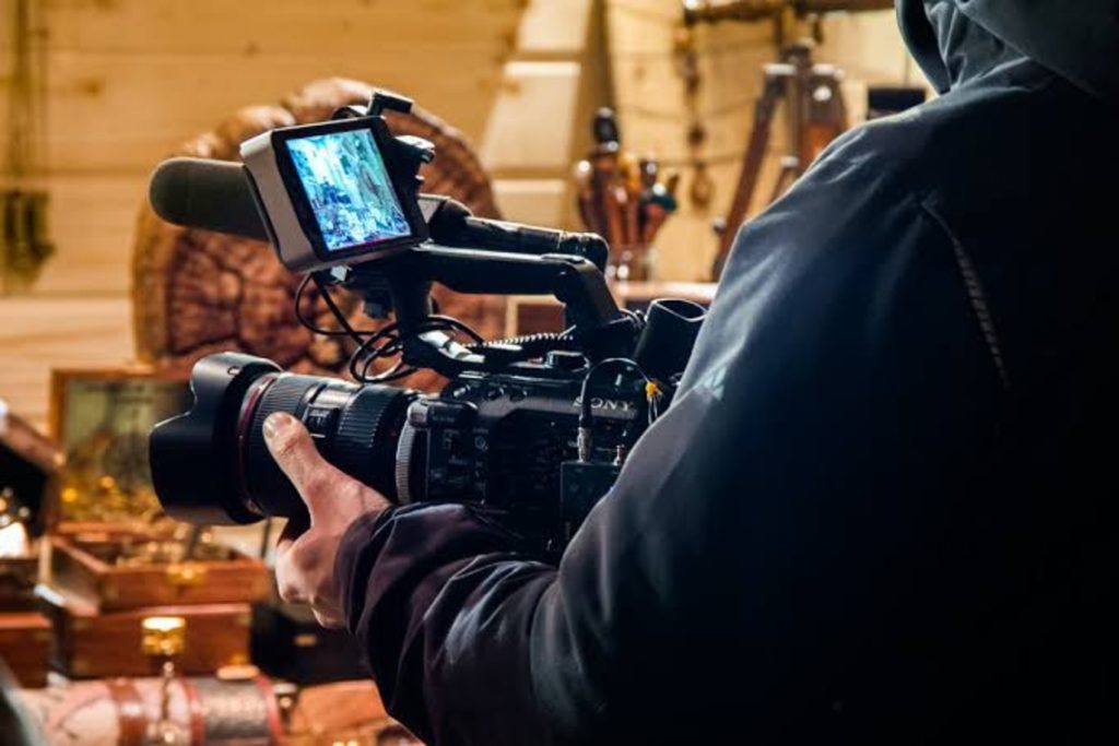 A camera operator filming a scene