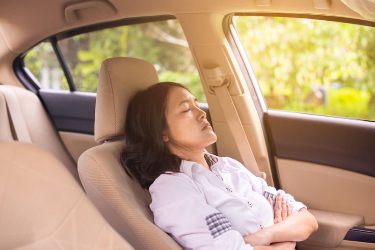 Woman sleeping in a car