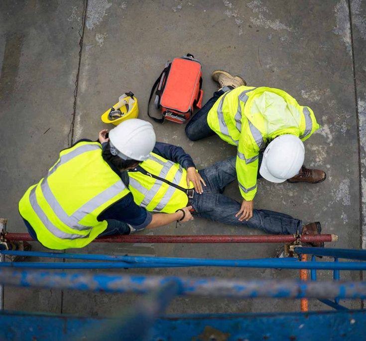 A picture of an injured factory worker with his colleagues