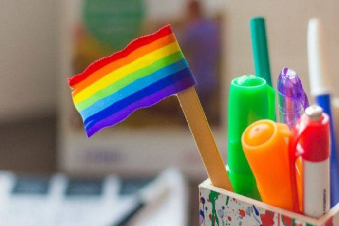 A picture of school materials and a pride flag
