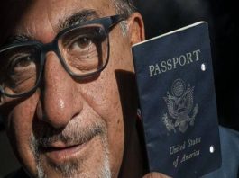 A pictured Siavash Sobhani, holding a black U.S. Passport