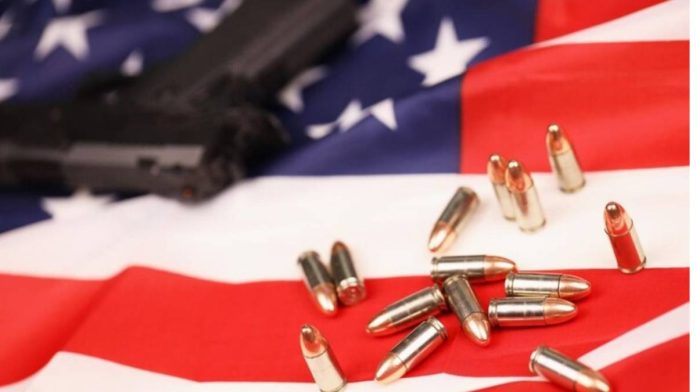 A handgun, 9 mm bullets, on a Union Jack
