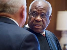 Justice Thomas (facing the camera) and Sonny Perdue