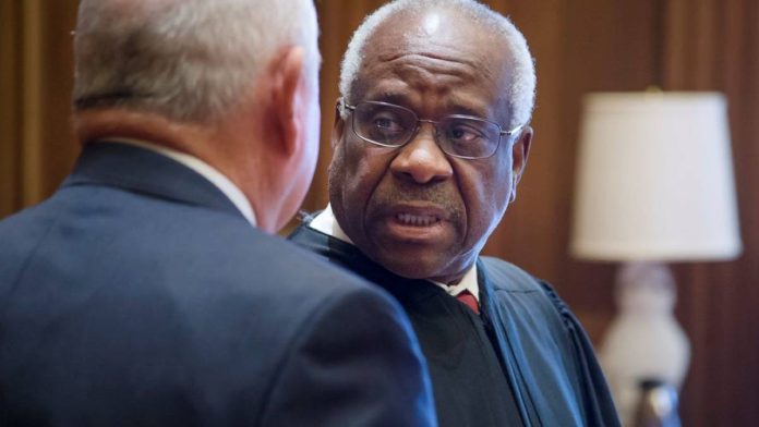 Justice Thomas (facing the camera) and Sonny Perdue