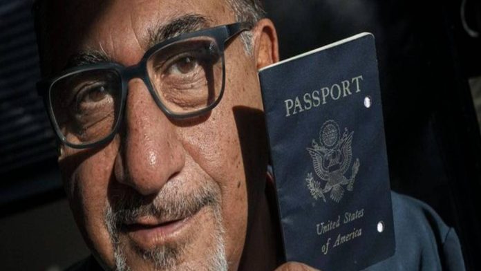 A pictured Siavash Sobhani, holding a black U.S. Passport