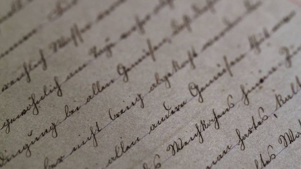 A sheer of paper with cursive writing