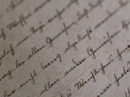 A sheer of paper with cursive writing