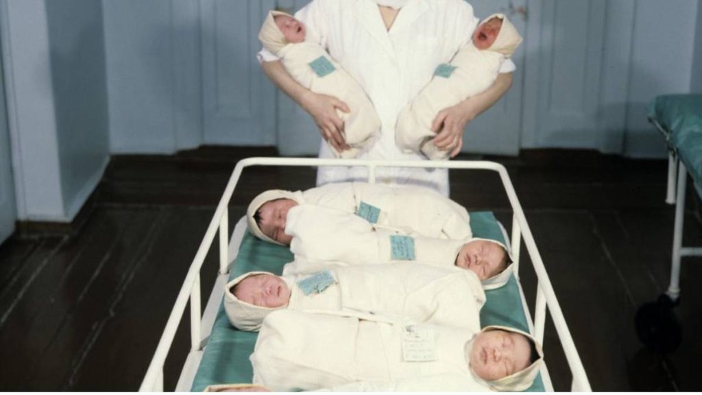 A matron attending babies in a maternity ward