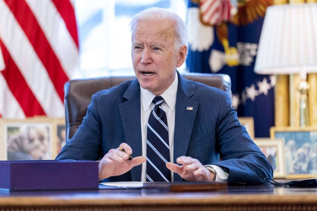 President Joe Biden sitting in office