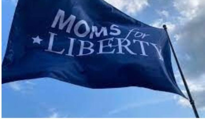 A Moms for liberty flag waving