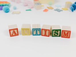 Letter Blocks Near Toy Pieces on the White Background