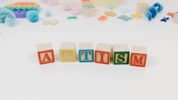 Letter Blocks Near Toy Pieces on the White Background