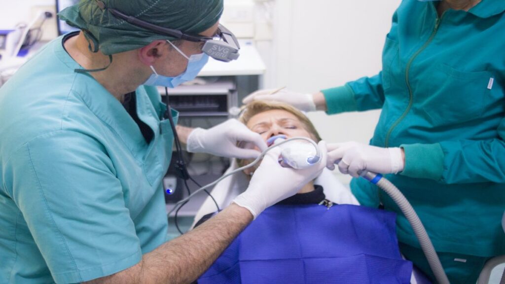 A picture of some dentists working on a patient