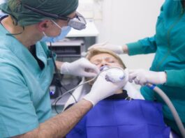 A picture of some dentists working on a patient