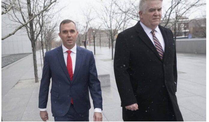 Jonathan J. Dunn, left, walking with his attorney following his first federal court appearance