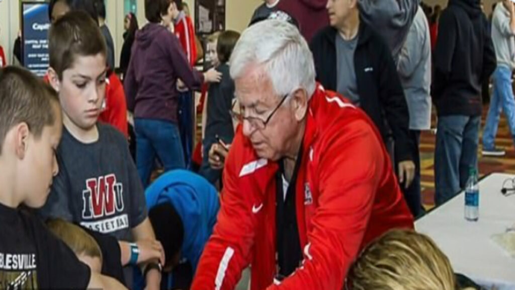 A picture of Terry Kahn and some children at an event.