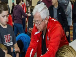 A picture of Terry Kahn and some children at an event.