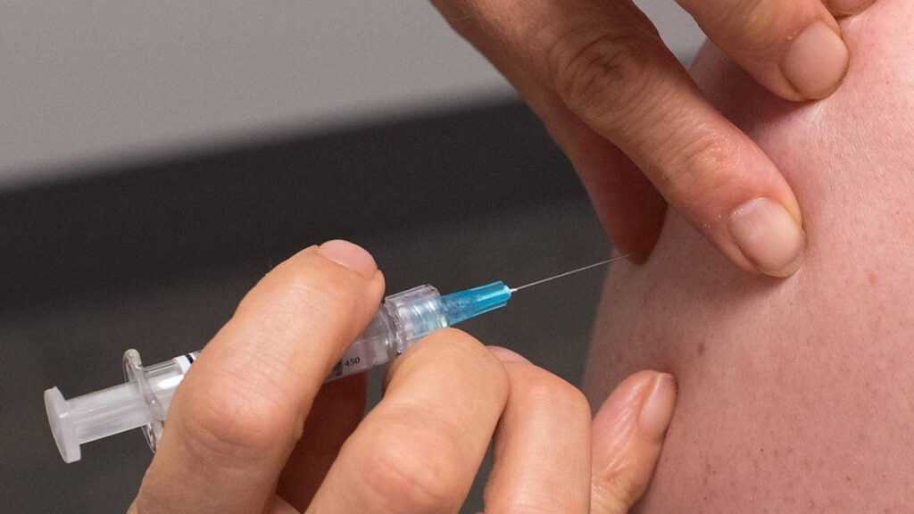 A patient is about to be vaccinated with a syringe