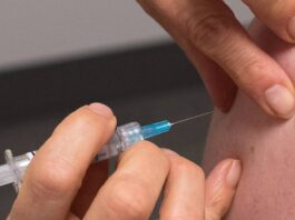 A patient is about to be vaccinated with a syringe