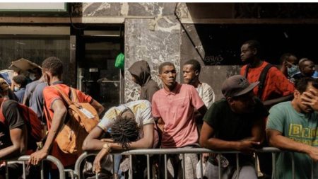 Migrants in a long queue waiting to get accommodation