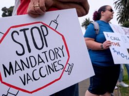 A mob of workers protesting enforcement of vaccine mandates