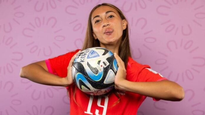 Phair posing with a soccer ball