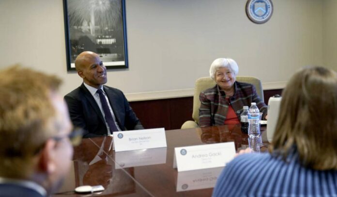 Janet Yellen and Treasury Undersecretary for Terrorism and Financial Intelligence Brian Nelson receive a briefing during a visit to the Financial Crimes Enforcement Network (FinCEN)