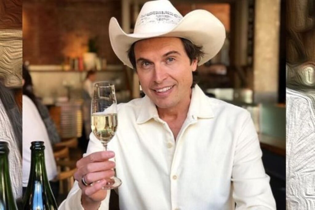 Kimball Musk wearing a cowboy hat and holding a glass of champagne
