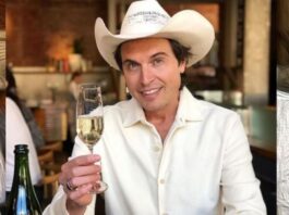 Kimball Musk wearing a cowboy hat and holding a glass of champagne