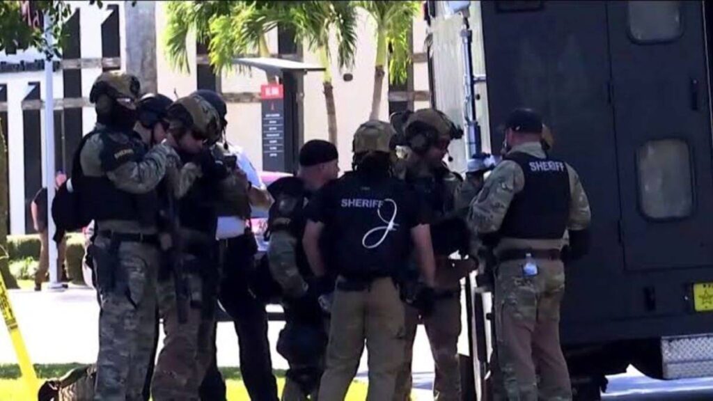 Deputies and members of the SWAT team standing around the bank building