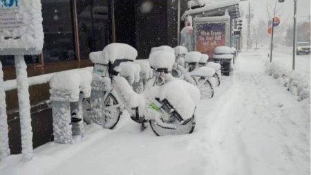 Bicycles covered with inches of snow