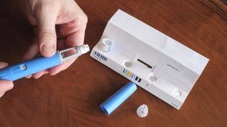 A user unboxing an Ozempic kit