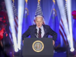 Joe Biden speaking to a crowd in a building