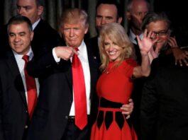 Kellyanne Conway stands in a hug pose with Donald Trump
