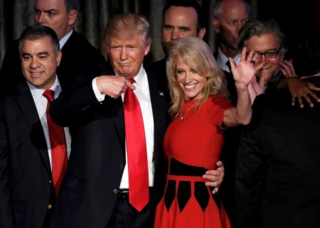 Kellyanne Conway stands in a hug pose with Donald Trump