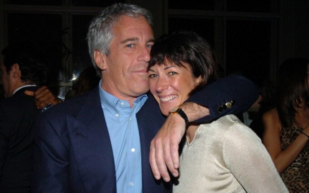 Jeffery Epstein in an embrace with a woman, a hand is over her shoulder and his nose seems to be in her hair.
